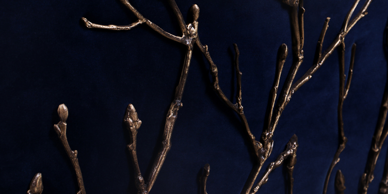 Close-up of the Koket Enchanted structure, showcasing intricate gold branch-like details against a dark background.