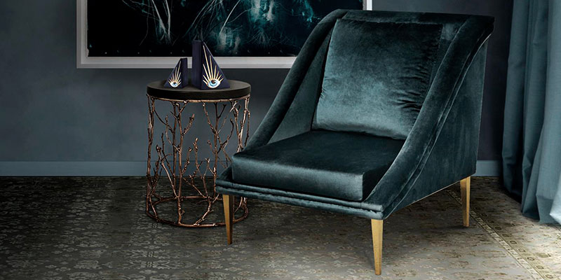 A plush green velvet Geisha Chair sits beside an Enchanted Ebony Veneer Top Side Table with a branch-like base.