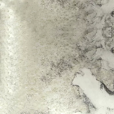 Close-up of an aged mirror surface with a distressed, cloudy texture and antique patina.