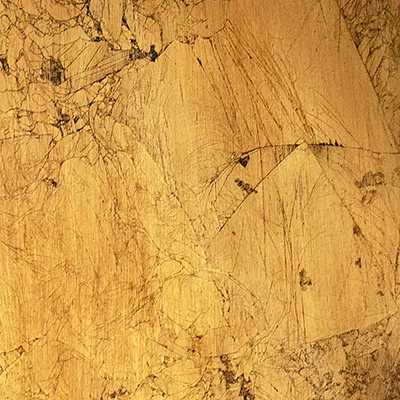 Close-up Broken Gold Leaf: irregular surface in pale golden tones with dark cracks and flaked areas, suggesting aged and fragmented gold leaf.