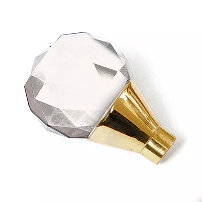 A close-up of a multifaceted, clear glass pull knob with a gold-toned base, showcasing Koket's Burlesque Clear Glass Pull.