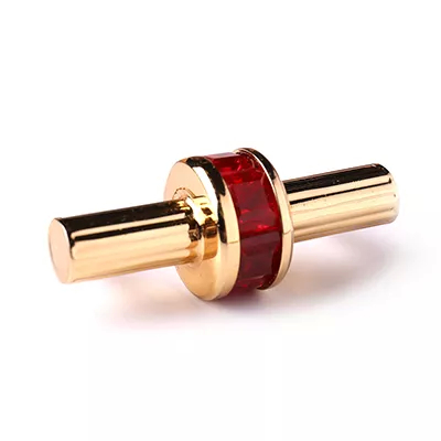 Gold cylindrical handle with a ruby red centerpiece, featuring Koket's exquisite Exotica Handle finish.