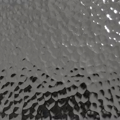 Close-up Hammered Stainless Steel (Gloss): stainless steel surface with an irregular hammered texture, featuring bumps and shiny reflections.