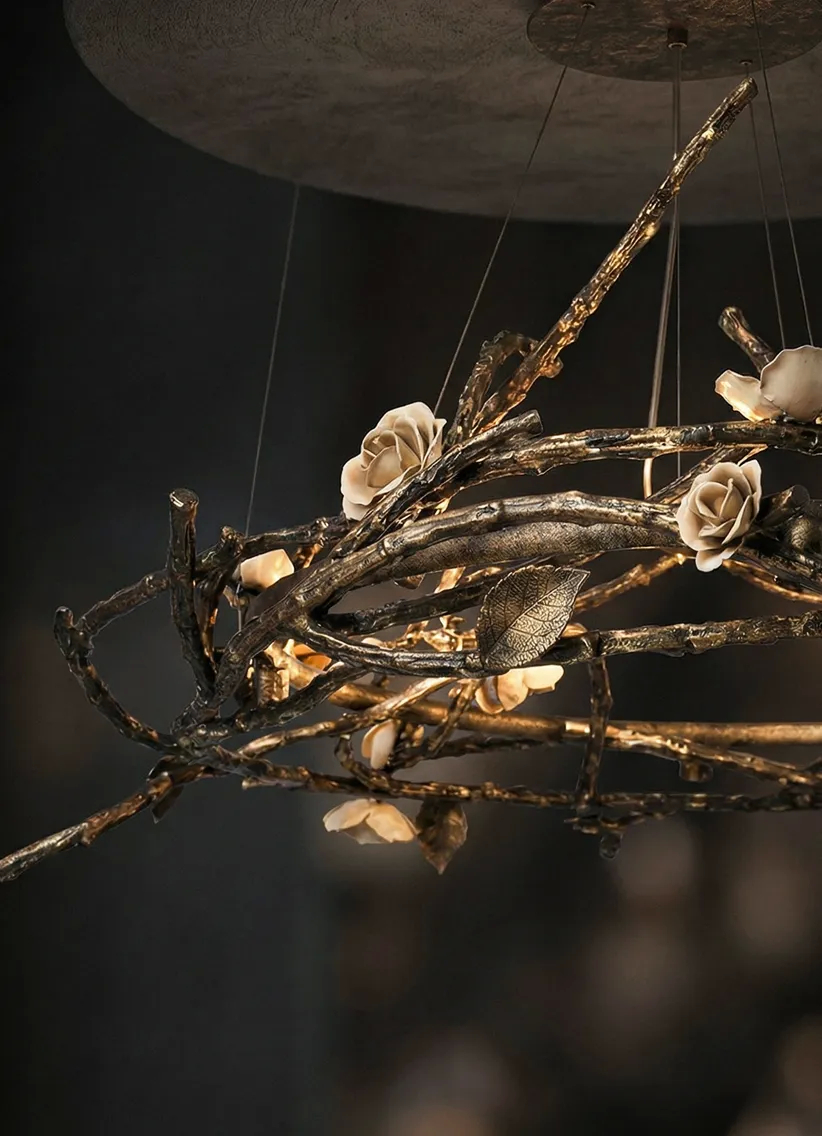 Rose Round Chandelier with intertwined antique gold branches and cream-lacquered porcelain roses—an artistic ceiling fixture blending nature-inspired elegance and ambient illumination.