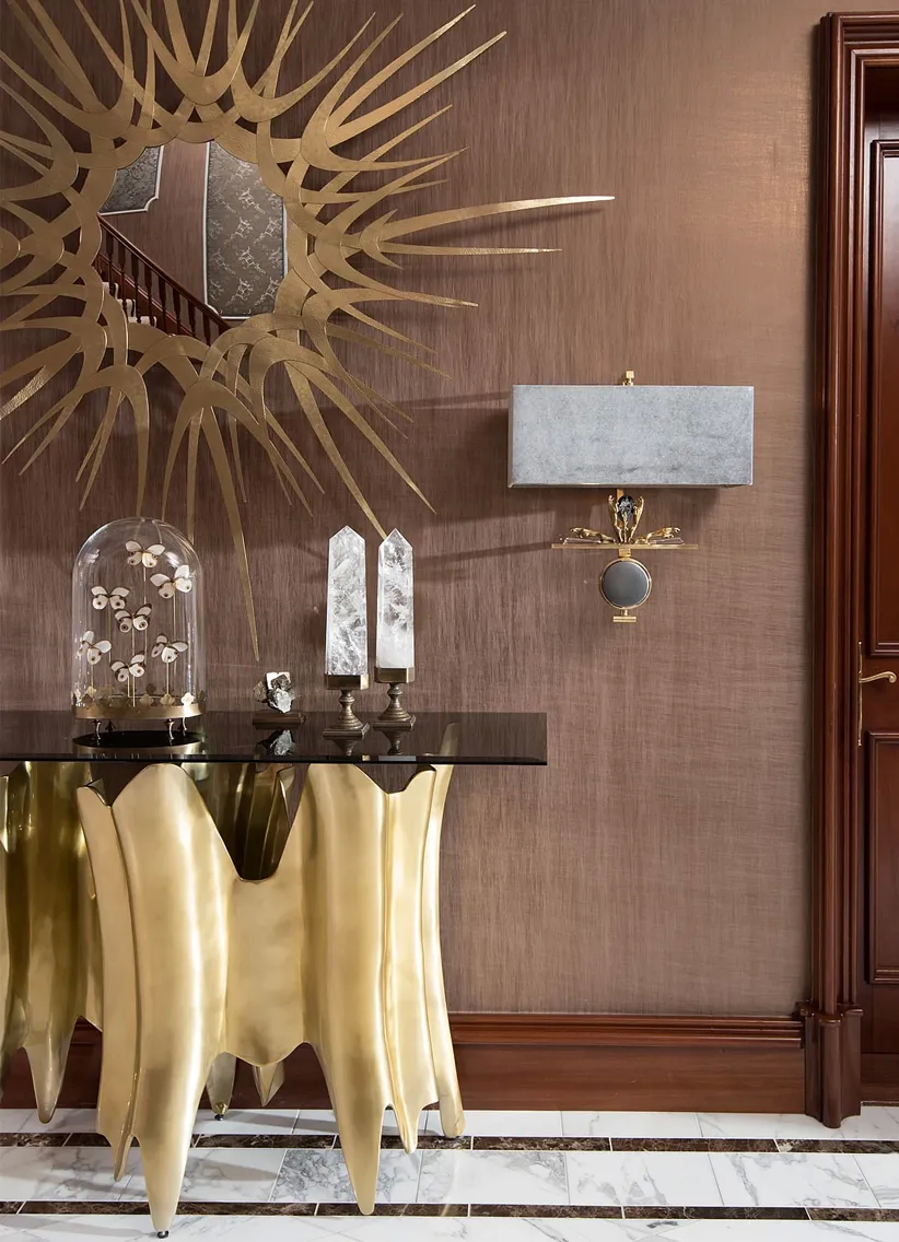A catalog showcases KOKET's designs around the globe, highlighting luxurious furniture pieces in elegant room settings.