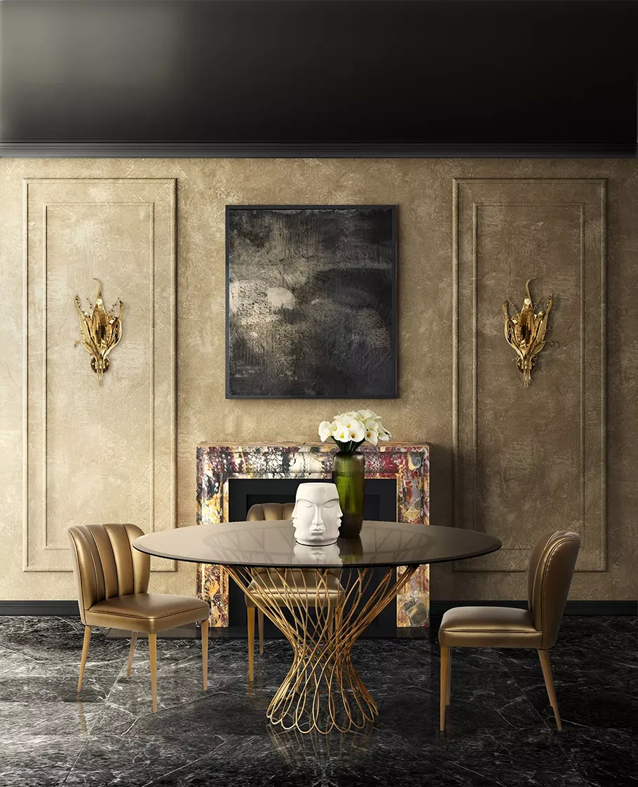 An opulent dining room features an Allure Dining Table by Koket, surrounded by chairs, and illuminated by Botanica Sconces.