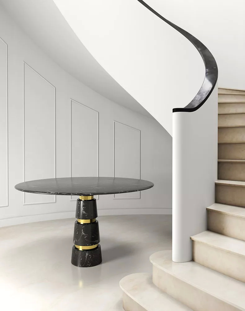 With refined simplicity, this entryway in neutral colors features an elegant curving staircase. The Avalanche Dining Table anchors the space with its dark surface with golden bands that gleam like quiet promises of luxury. Every detail speaks of quiet sophistication.