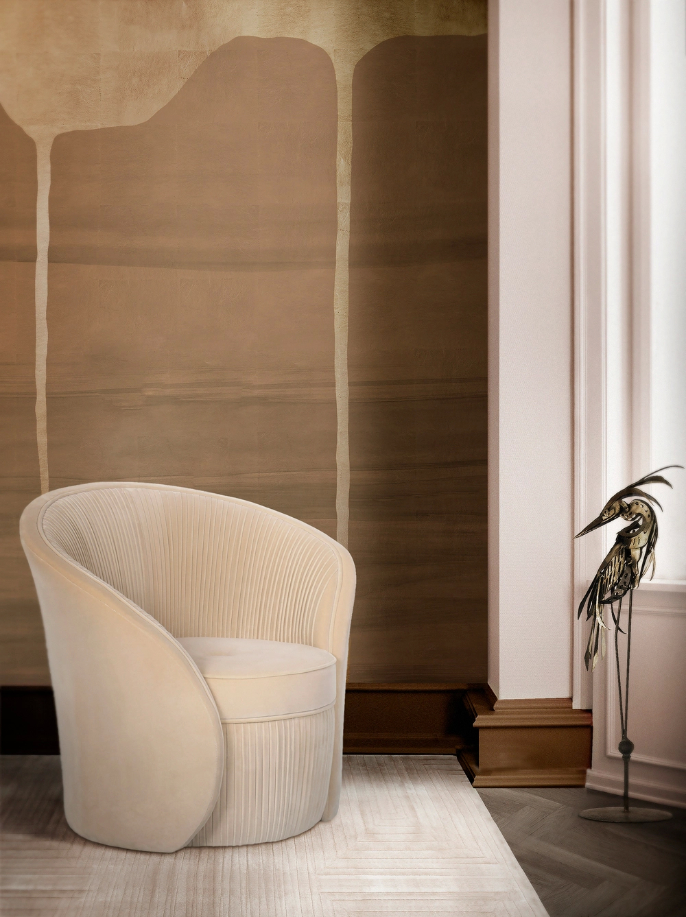 Cream-colored Bloom Chair by KOKET with pleated upholstery and curved silhouette in a modern interior with a bird sculpture.