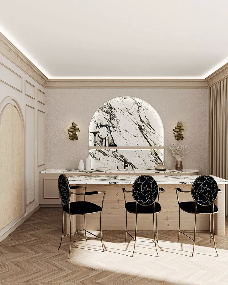 A luxurious kitchen features three Enchanted Bar Stools by Koket at a marble island, with a large marble arch backsplash.
