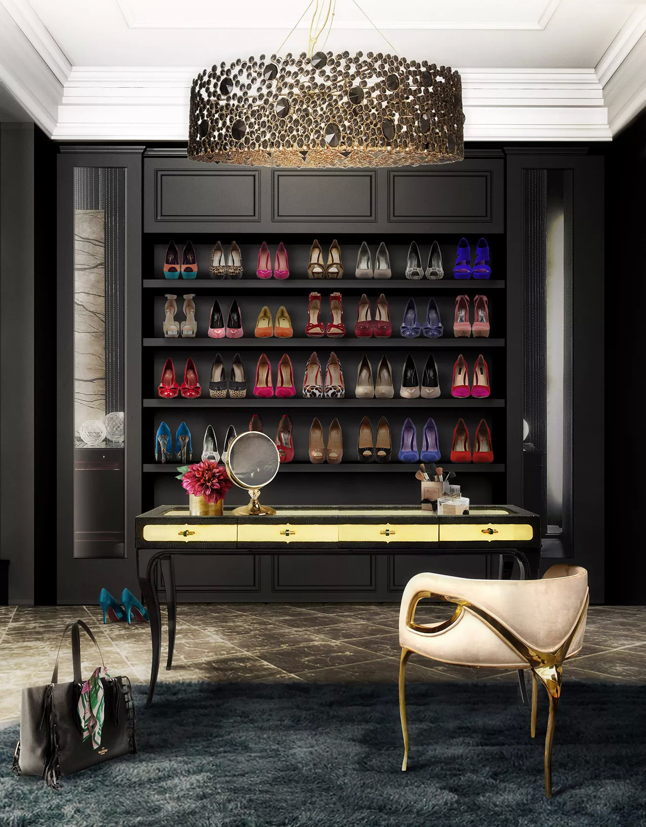 A closet in dark hues, with shelves filled with high-heel shoes in various colors. In the center, an Exotic Desk in black and golden hues, with a mirror and flowers as decorations. By the desk, there is a Chandra Chair, demonstrating its distinctive feature of only having 3 legs, contrasting with the elegant cream upholstery. Above, there is an Eternity Chandelier with black and clear stones, casting a glamourous light over the space.