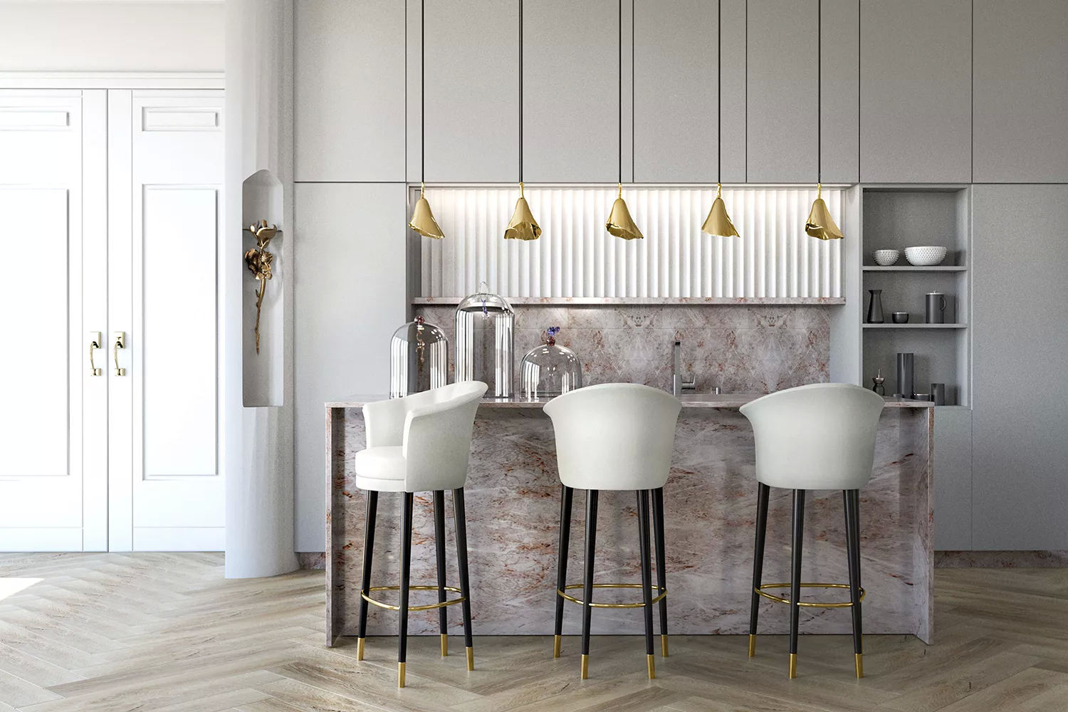 A simple kitchen in bright, soft hues with a marble center island, adding a touch of class to the space. The golden accents of the Gia Pendant and Flora Sconce, inspired in floral motifs, elevate the elegance, beautifully complemented by the creamy white upholstery of the Besame Bar Stools.