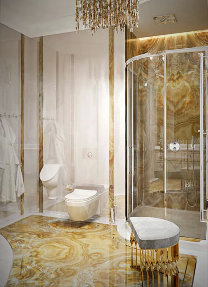 This bathroom is immersed in white and golden hues. The marble, in those same colors, brings a sense of luxury to the space. A Mandy Stool is set by the shower and brings a sense of comfort while still maintaining the elegance, with its grey upholstery and golden twisted structure.