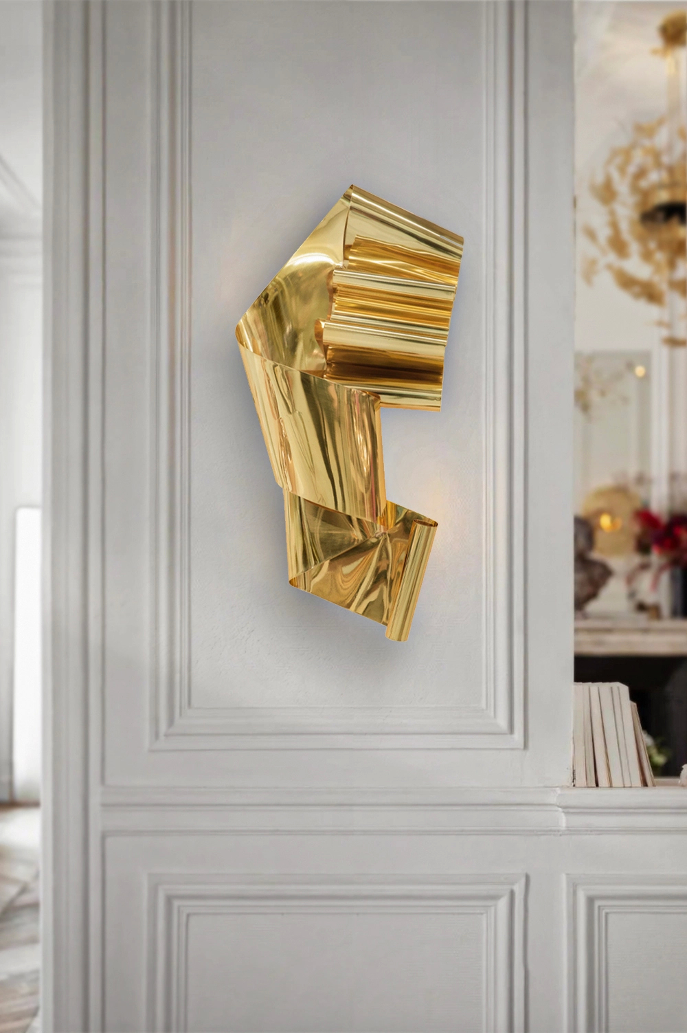 A gold wall light hang on a wall, creating a warm ambiance.