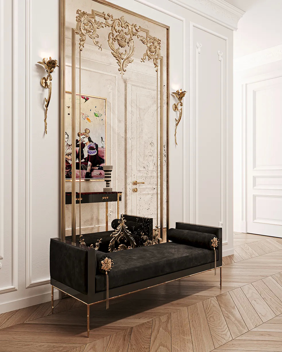A luxurious Privê Daybed in black and gold in a grand hallway, flanked by ornate Flora Sconces and a large mirror.