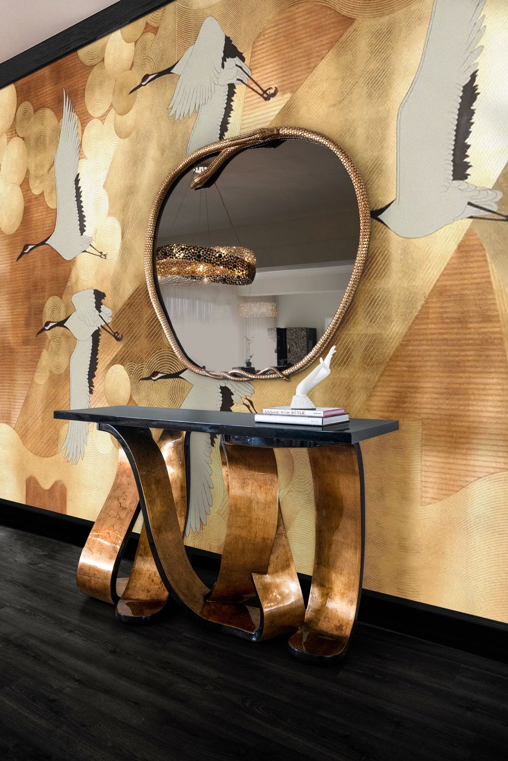A modern interior with a gold Ribbon Console table and a serpentine-framed mirror, against a wall with a crane pattern.