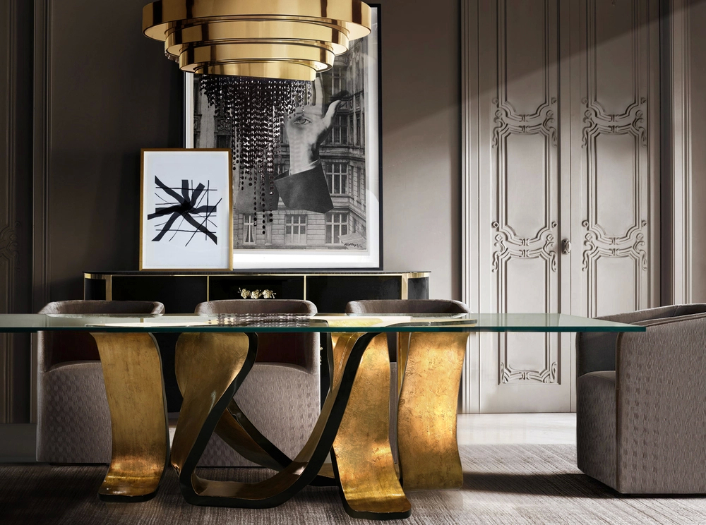This modern dining space exudes contemporary sophistication, adorned in luxurious golden details. The focal point is the stunning Ribbon Dining Table with an intricate base, gracefully swirling. Its fluid design creates a sense of lightness and artistry, while the golden tones add a warm, inviting glow to the room. Surrounding the table, sleek furniture complements the modern aesthetic, allowing the ribbon-inspired base to shine as a true masterpiece. This is a dining room where sculptural beauty and refined luxury come together in perfect harmony.