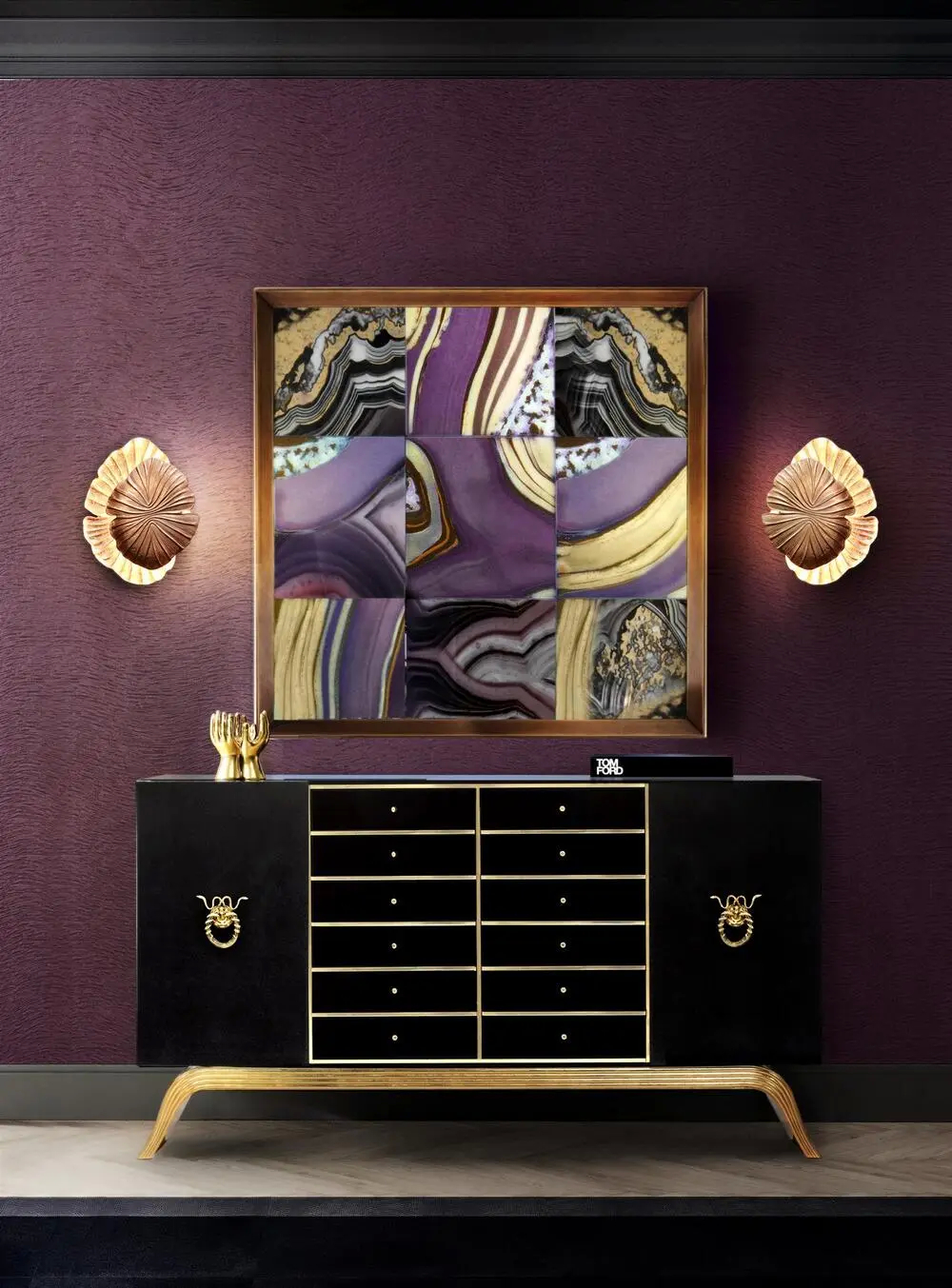 In a striking display of luxury, the Sinful Cabinet commands attention with its bold black silhouette and shimmering golden accents. Each drawer is outlined in delicate brass, creating a refined contrast against the deep black finish. Above, an agate-inspired art piece with rich purple and earthy hues and two intricate Passion Sconces complement the cabinet’s allure, adding depth and warmth to the space. Together, this ensemble becomes a captivating focal point, embodying elegance and high style.