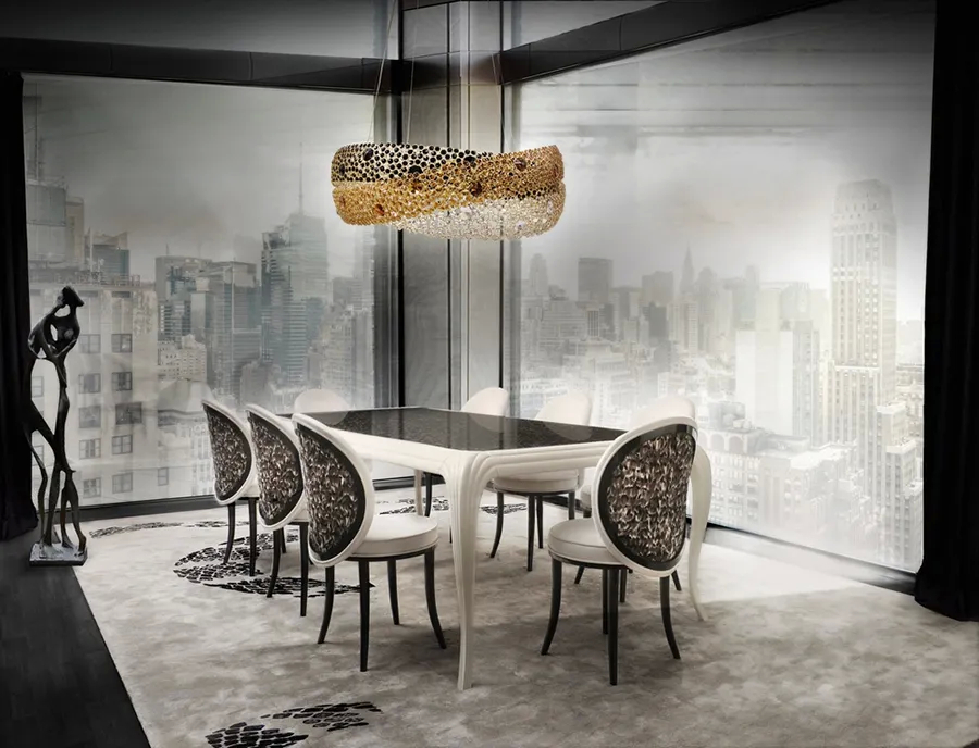 An elegant dining room features the Merveille Dining Table and Chairs and the Trinity Chandelier by Koket, with luxurious details and sophisticated lighting.