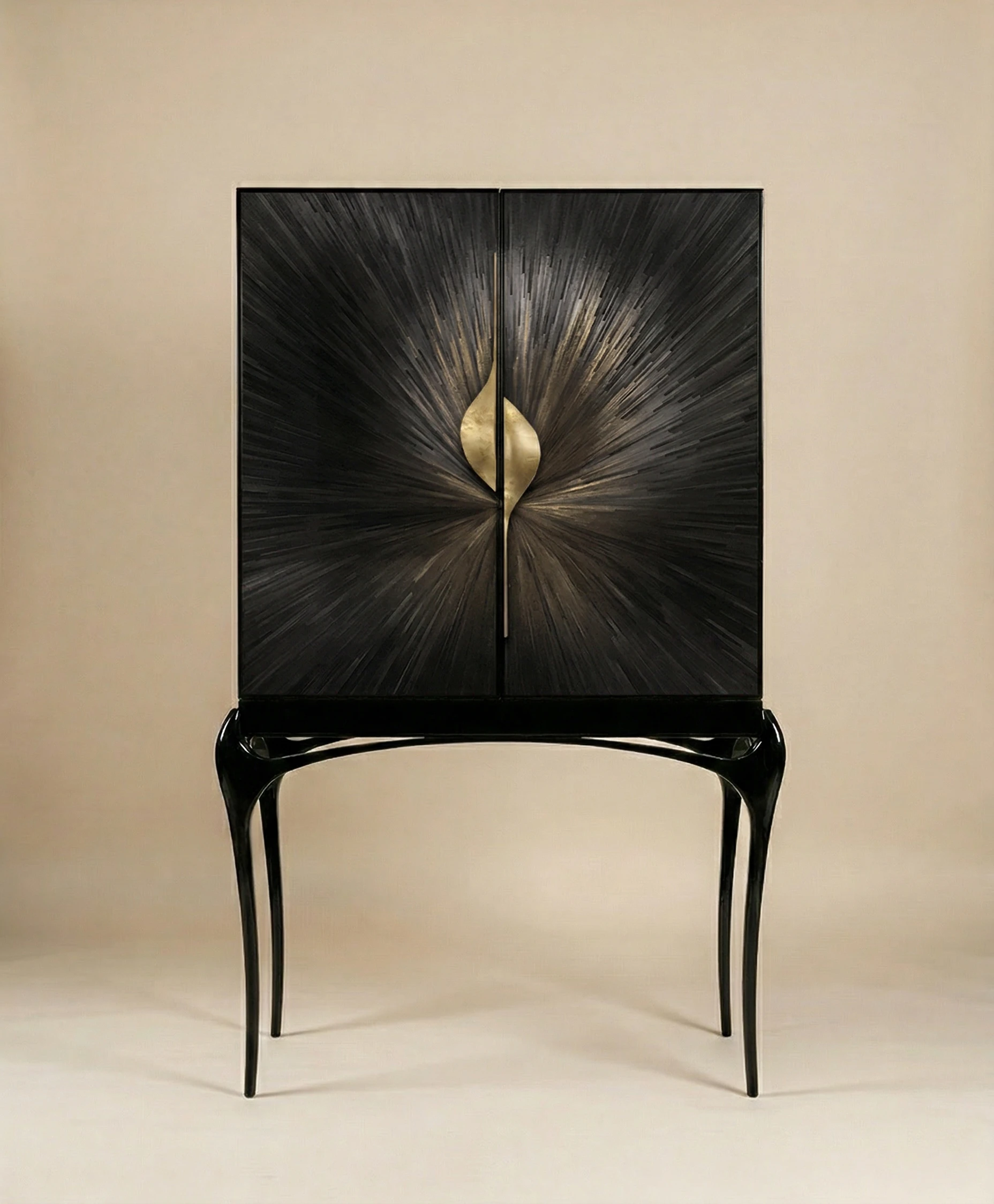 Luxury cabinet with dark textured radial doors, sculptural black legs, and a central gold leaf-shaped handle on a neutral background.