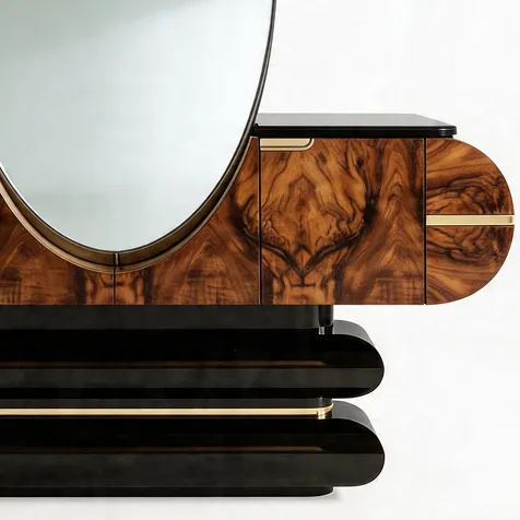 Close-up of KOKET Women Art Deco chest with oval mirror, warm wood veneer, black lacquer layers and gold detailing.