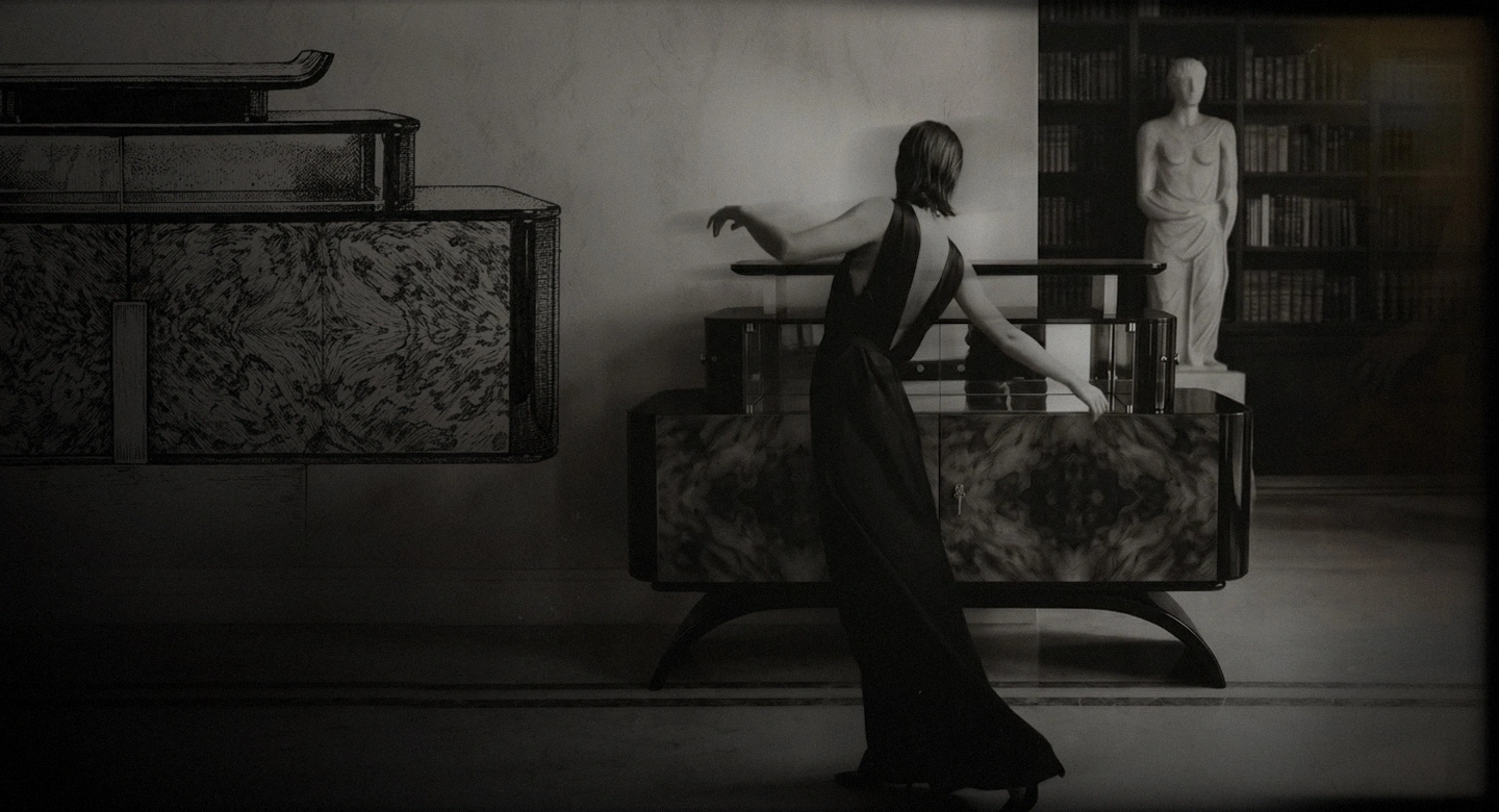 KOKET Women Art Deco hero image featuring a luxury chest with rich wood veneer, black lacquer curves, glass storage and editorial styling.