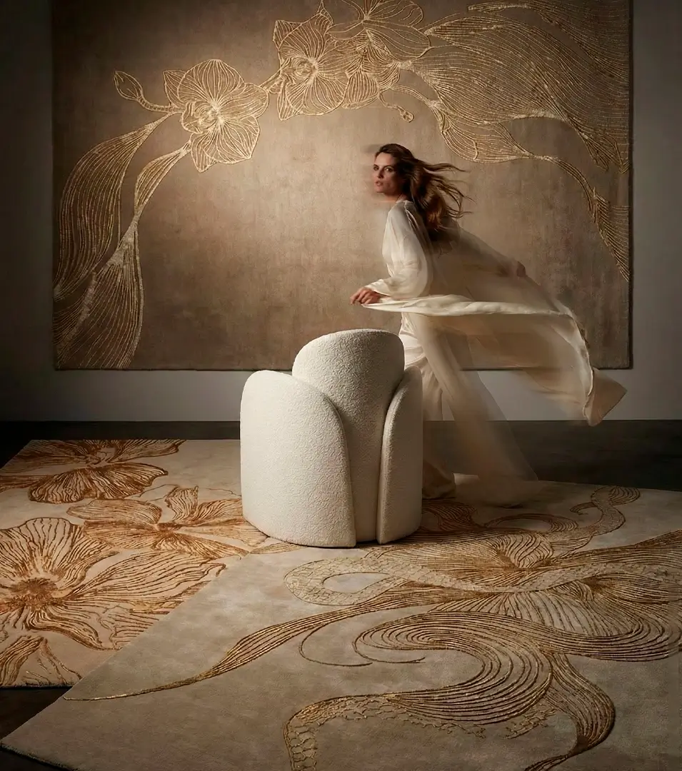 Exquisite KOKET silk rug featuring 3D gold orchid embroidery. This luxury botanical carpet collection transforms high-end interiors with artistic textures and metallic champagne tones.