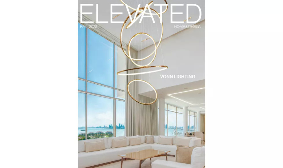 Press clipping of Elevated Luxury magazine cover, featuring a modern living room with a large chandelier and ocean view.