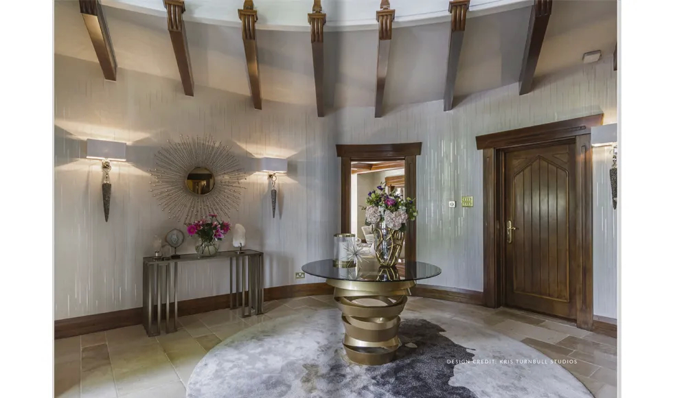 KOKET Intuition Dining Table paired with Brilliance Sconce showcasing elegant sculptural design.