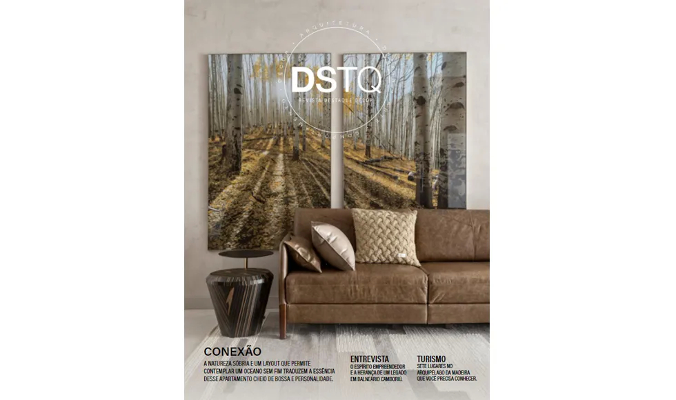 Destaque Decor magazine cover featuring a living room with a brown leather sofa and two large nature-themed wall art pieces.