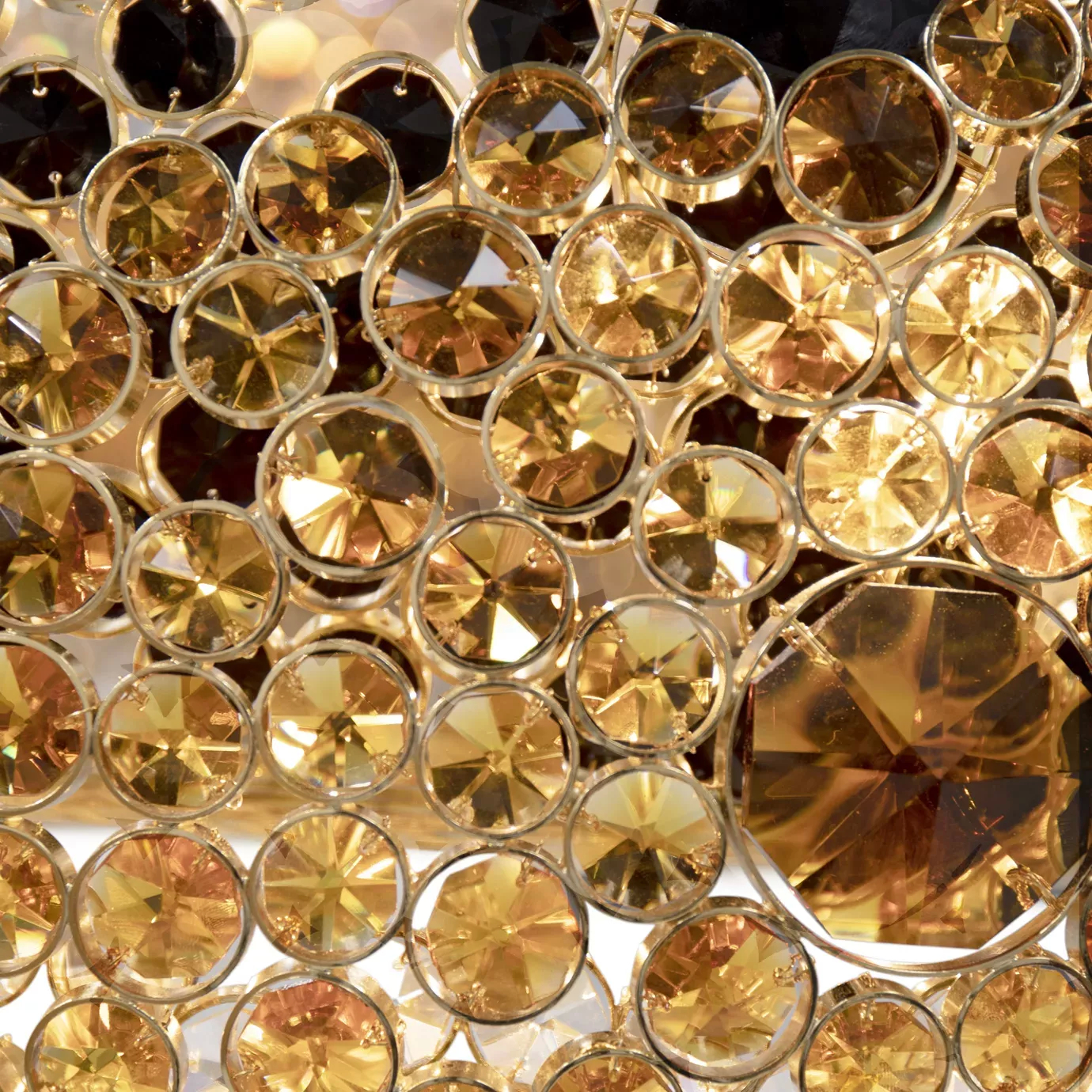 Close-up of the Trinity Chandelier showing its dazzling array of gold and black crystals.