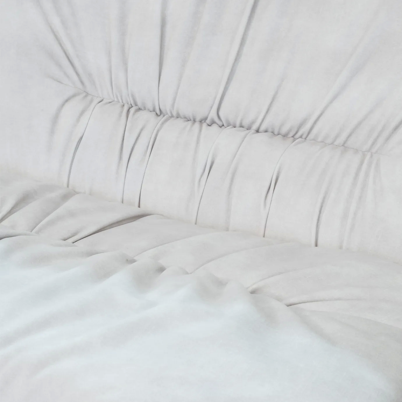 White, pleated Cleopatra Lounge Chair upholstery, showing texture and soft folds.