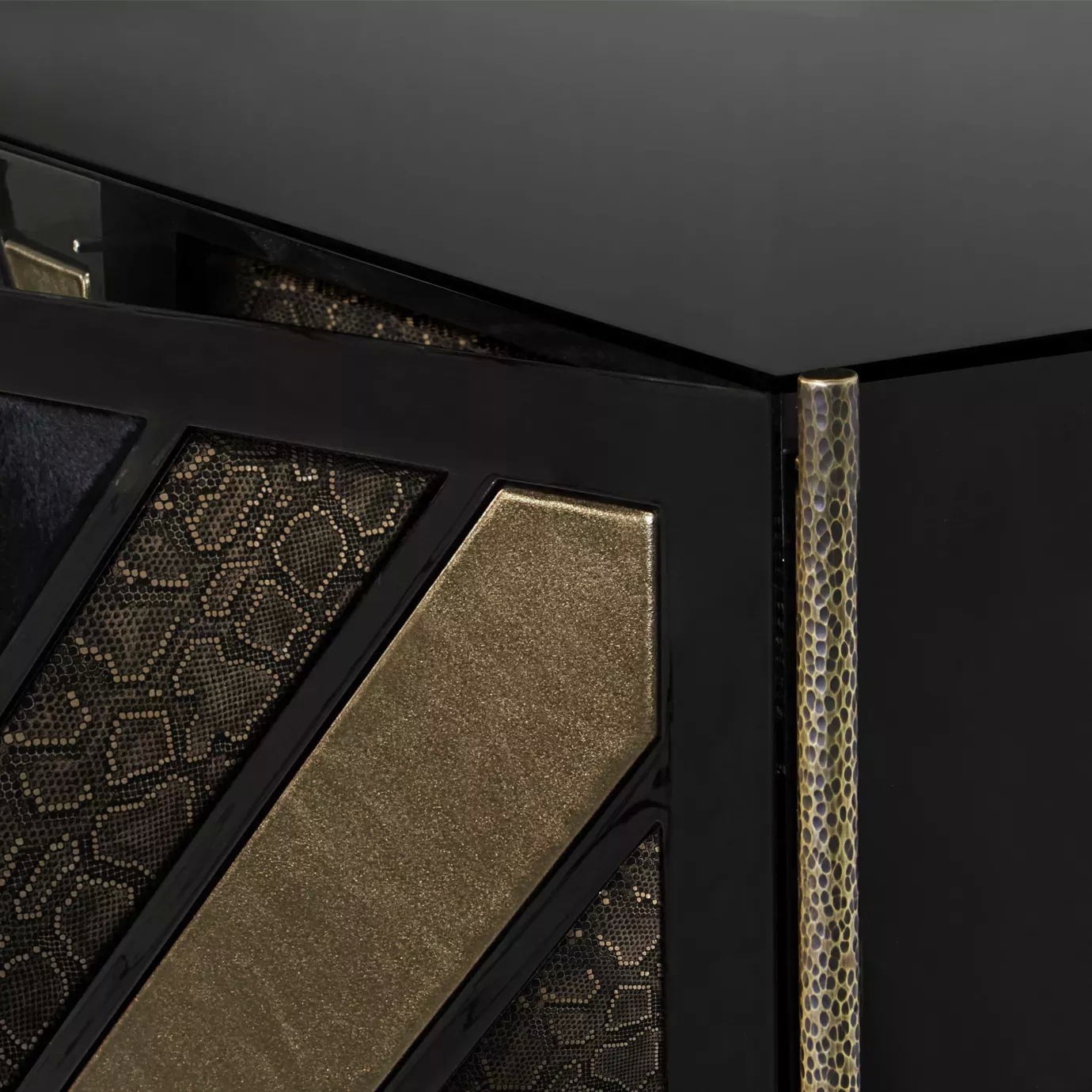 Detailed corner of the elegant black and gold Opium Cabinet with textures.