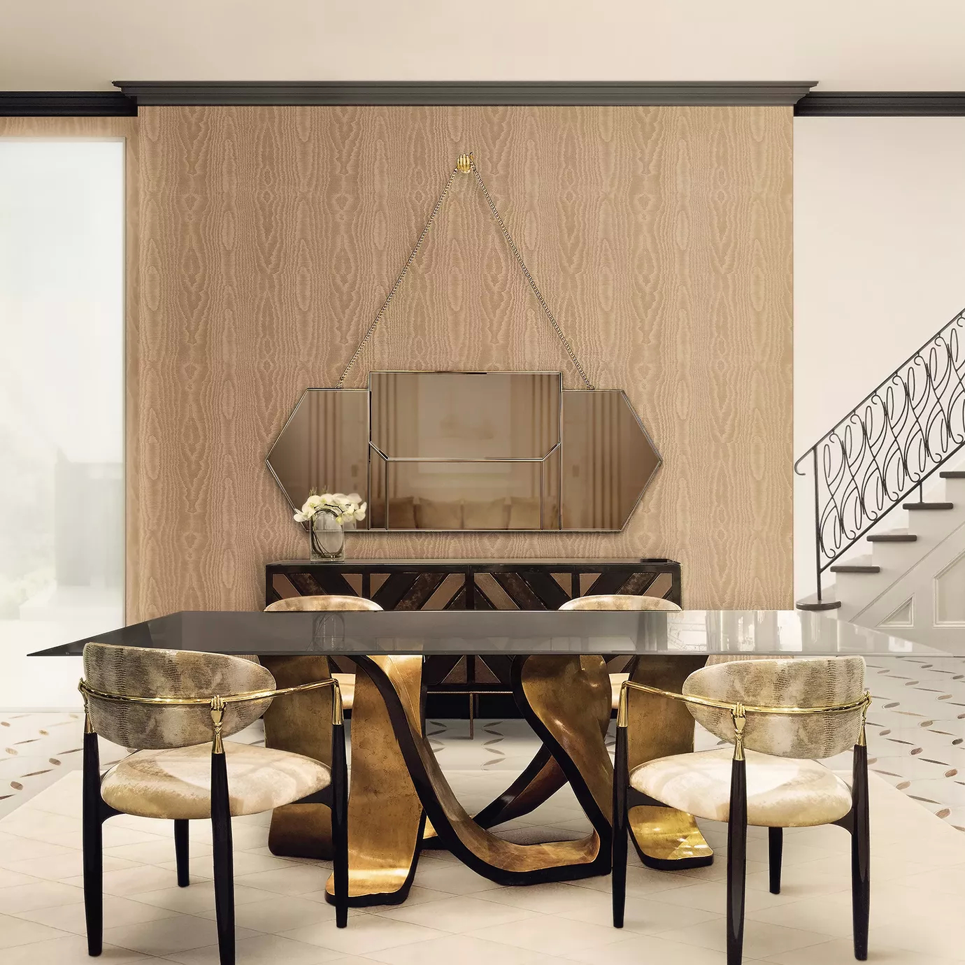 A neutral toned dining room showcasing four Nahéma Chairs in cream tones around a glass table with a golden structure. A geometric mirror hangs on a textured wall above a sideboard.