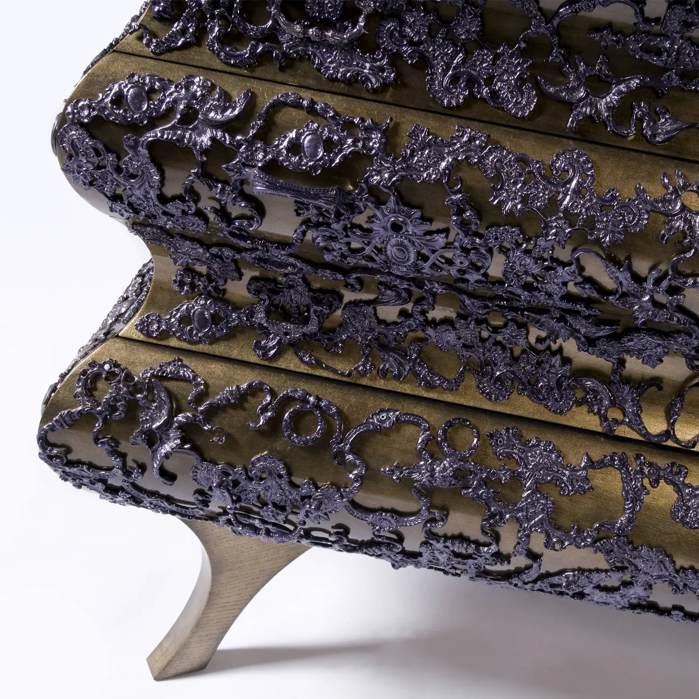 Side view of gold chest with hammered metal texture and crochet-inspired pattern on all drawers.