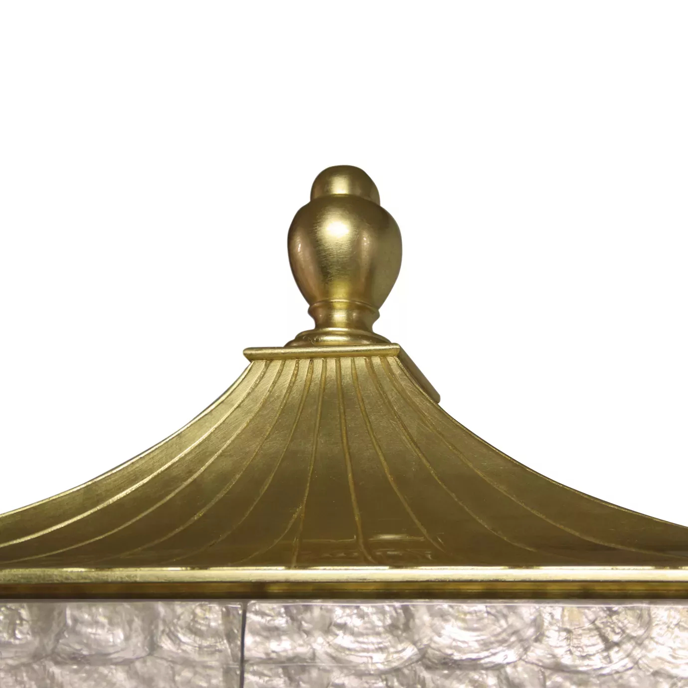 A close-up of the Camilia Mother of Pearl Armoire's golden, pagoda-style top with a decorative finial.