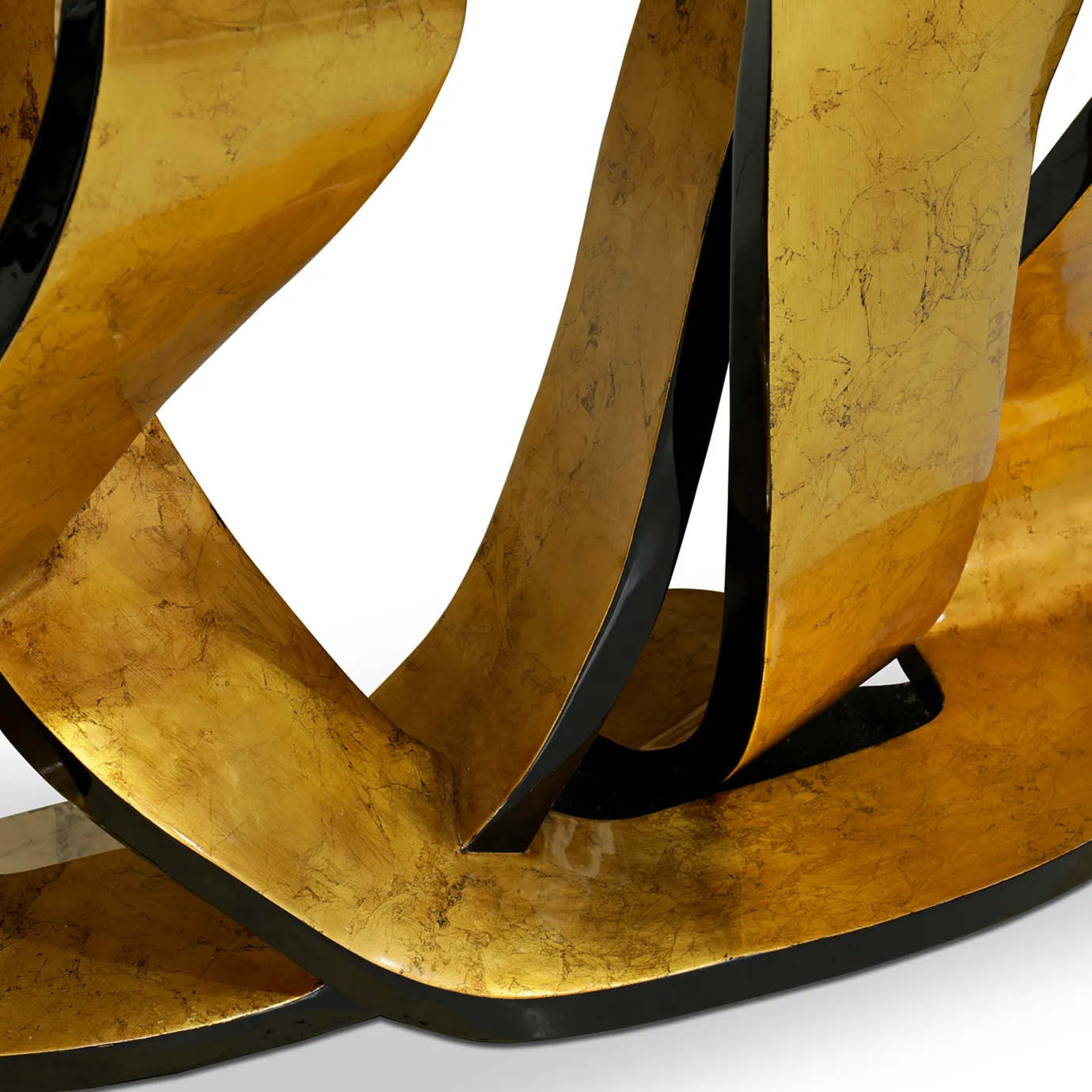 A close-up of the Ribbon Broken Gold Leaf Console highlights the texture of its golden, ribbon-like base.