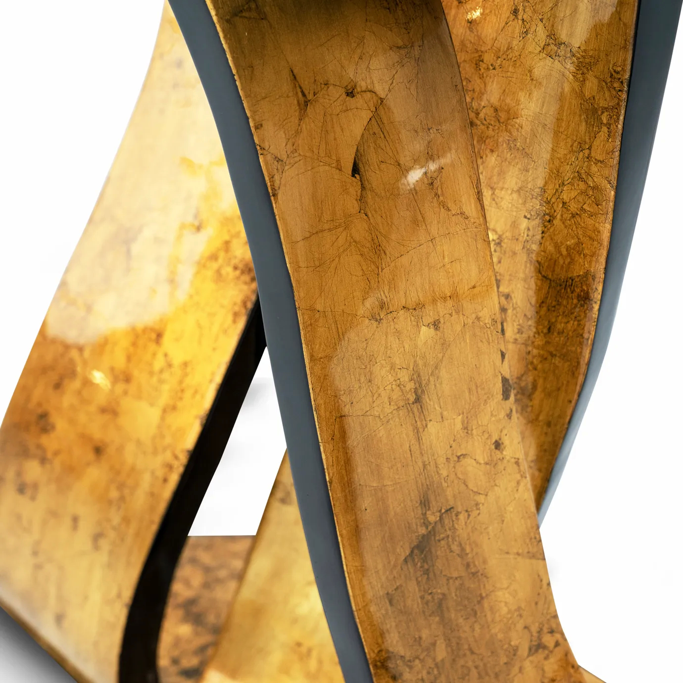 A detailed close-up of the Ribbon Broken Gold Leaf Console shows its textured gold leaf finish with black lacquered edges.
