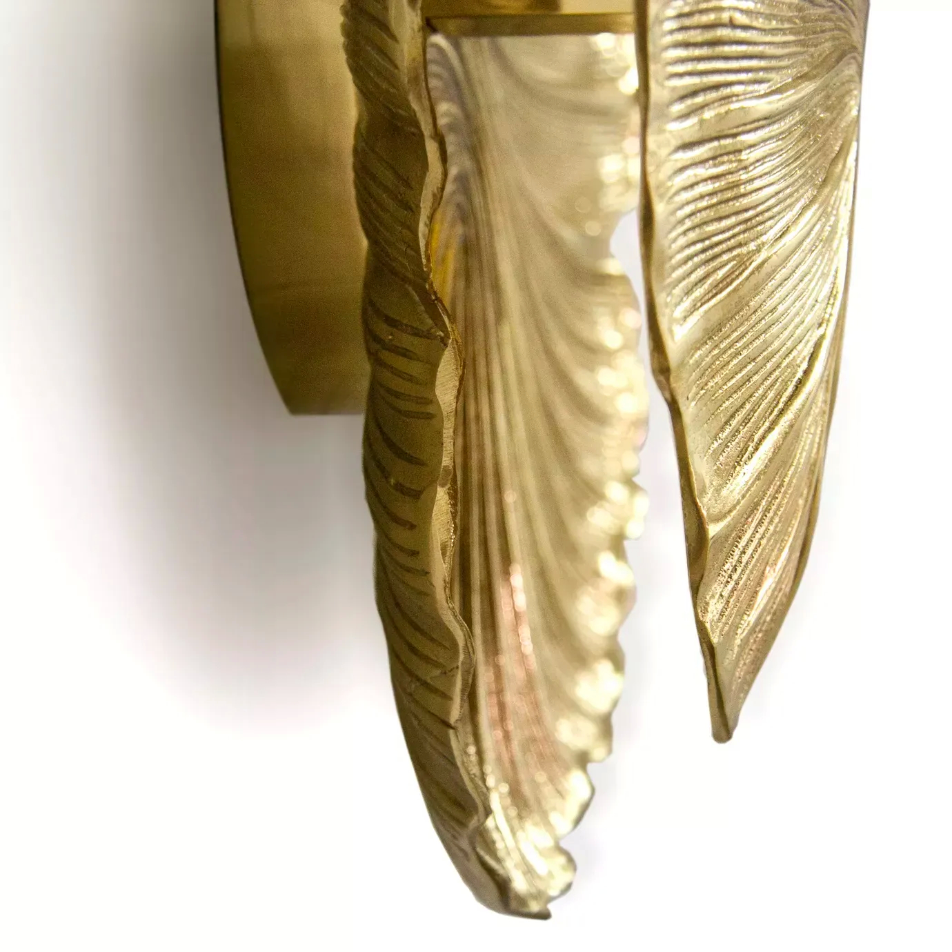 A dynamic close-up of the Passion Sconce by Koket, highlighting its layered, golden leaf design with intricate textures.