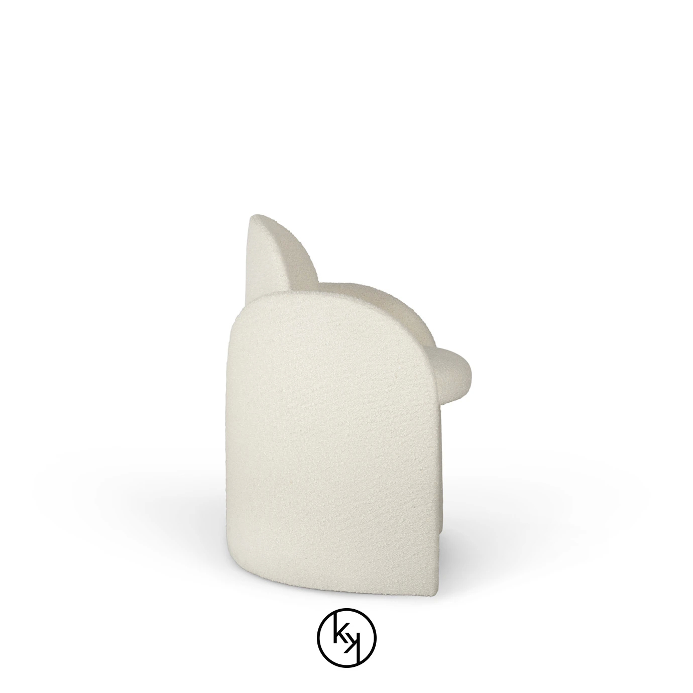 A cream-colored, plush Oh là là Chair by Koket, viewed from a side angle, showcasing its rounded silhouette and soft texture.