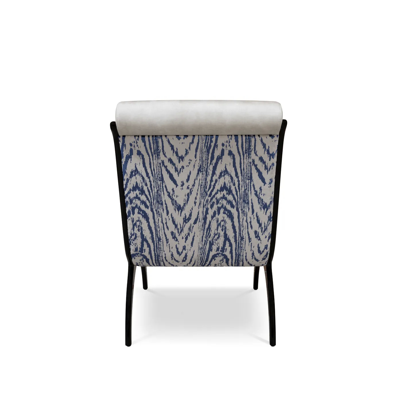 A Fever Chair in plush white upholstery, with a patterned blue and white back and elegant black legs, on white.
