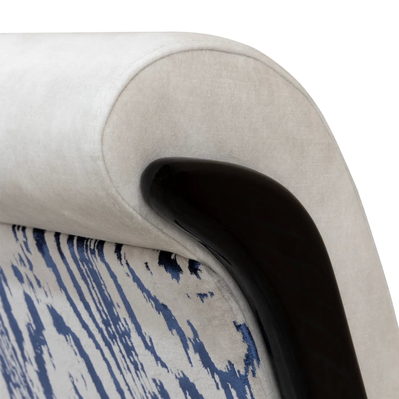 A luxurious Fever Chair in a smooth, light-colored fabric with a striking dark, curved base, against a white background.