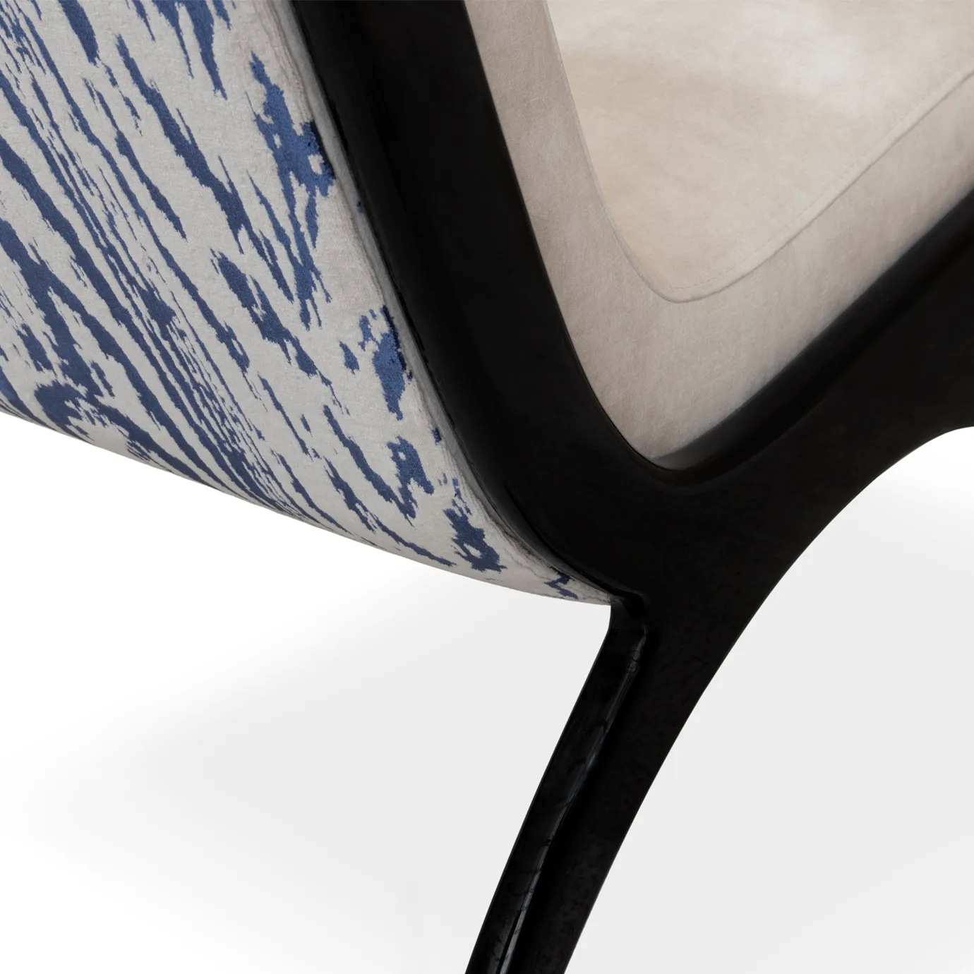 A modern Fever Chair, featuring a striking blue and white patterned fabric and sleek black legs.