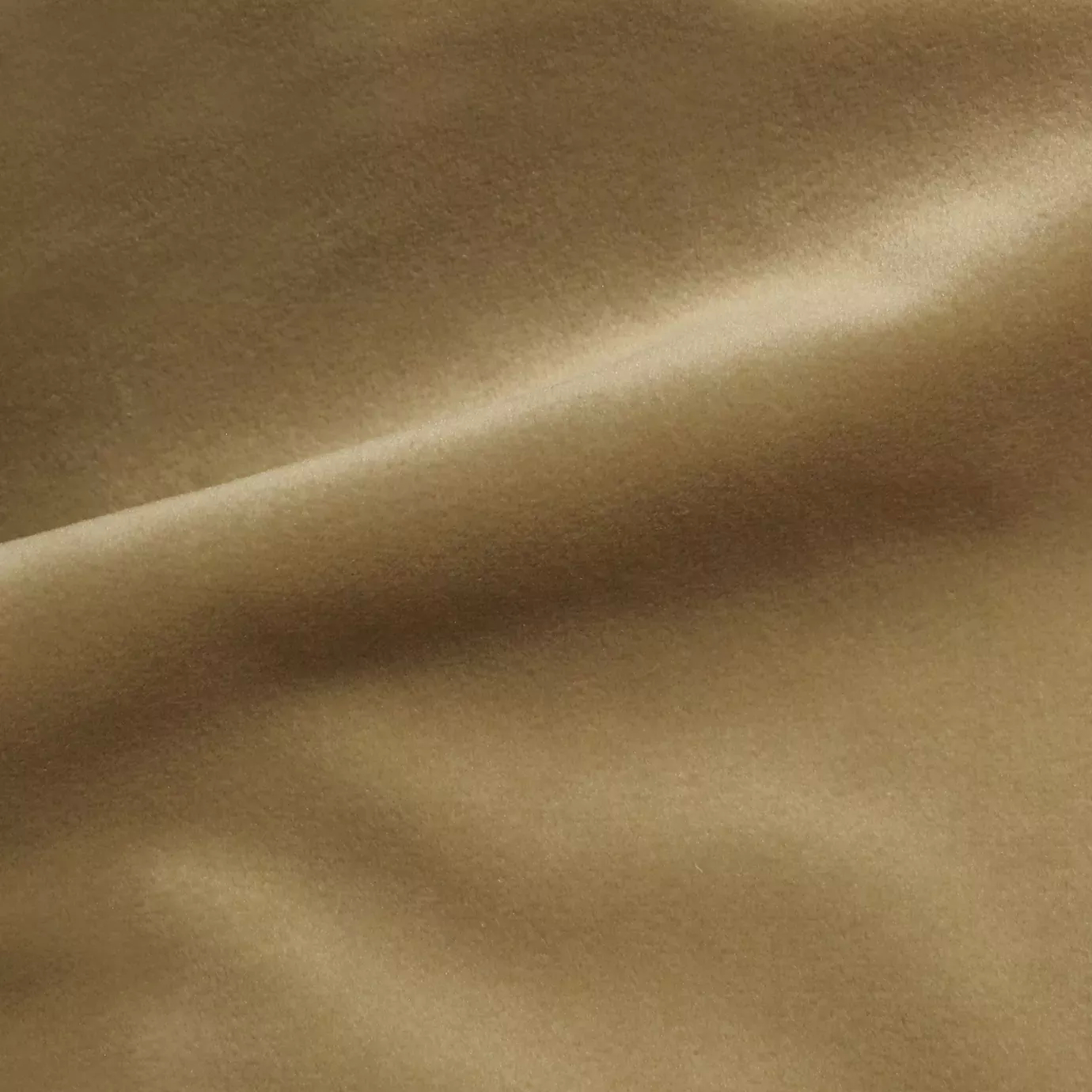 Elegant close-up of a Cozy Velvet fabric swatch in a soft beige tone, showcasing its smooth and slightly lustrous texture with gentle folds.