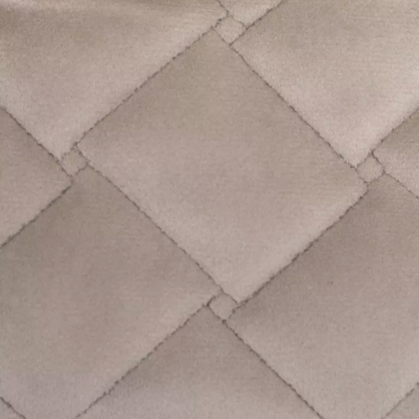 Close-up of a Cloud Velvet fabric swatch in a pale and soft pink tone, featuring a diamond-quilted pattern that gives it a dimensional texture and a soft touch, evoking a feeling of comfort and delicate elegance.
