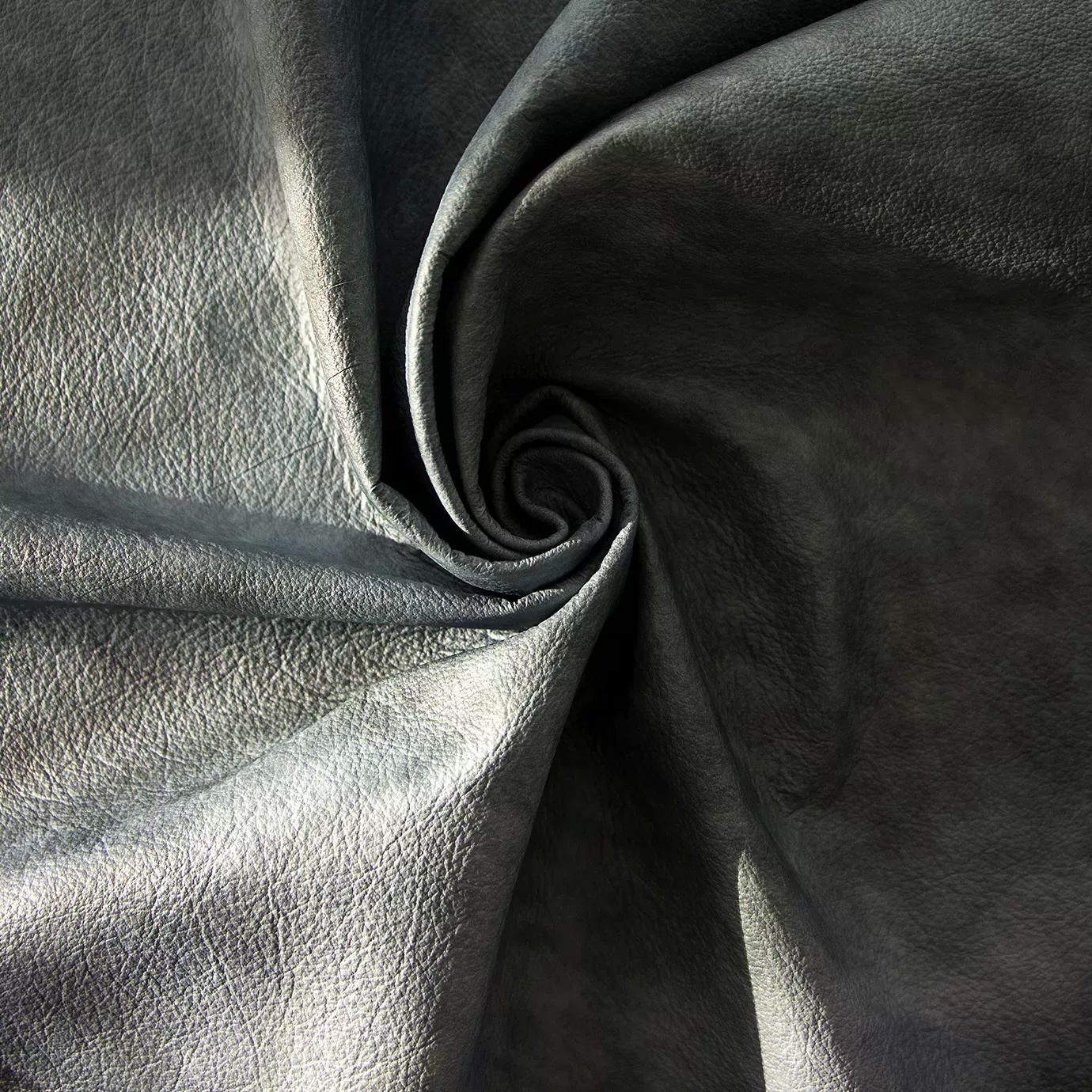 Elegant close-up of a Watermark Aqua Leather swatch in a soft aquatic tone with a subtle watermark effect, featuring a natural grain texture that gives it depth and a supple touch, evoking a feeling of freshness and organic elegance.
