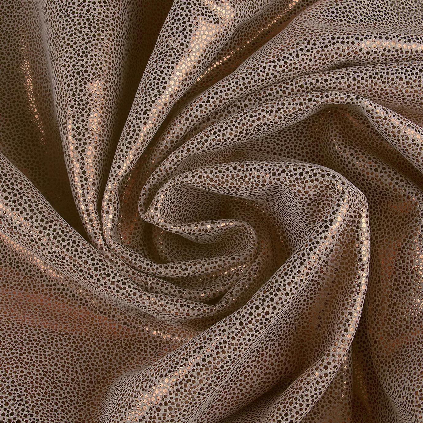 Elegant close-up of a Crico Leather swatch with a textured pattern of small dots in beige and metallic bronze tones, featuring a smooth surface with a warm shimmer and soft reflections in the folds, evoking a feeling of textured luxury and a touch of warmth.