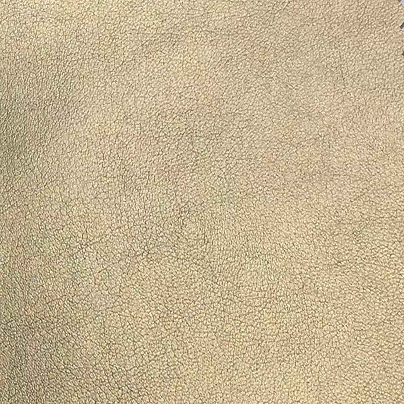 A detailed view of Komodo Synthetic Leather reveals a fine, slightly raised texture with subtle variations in a warm, golden hue.