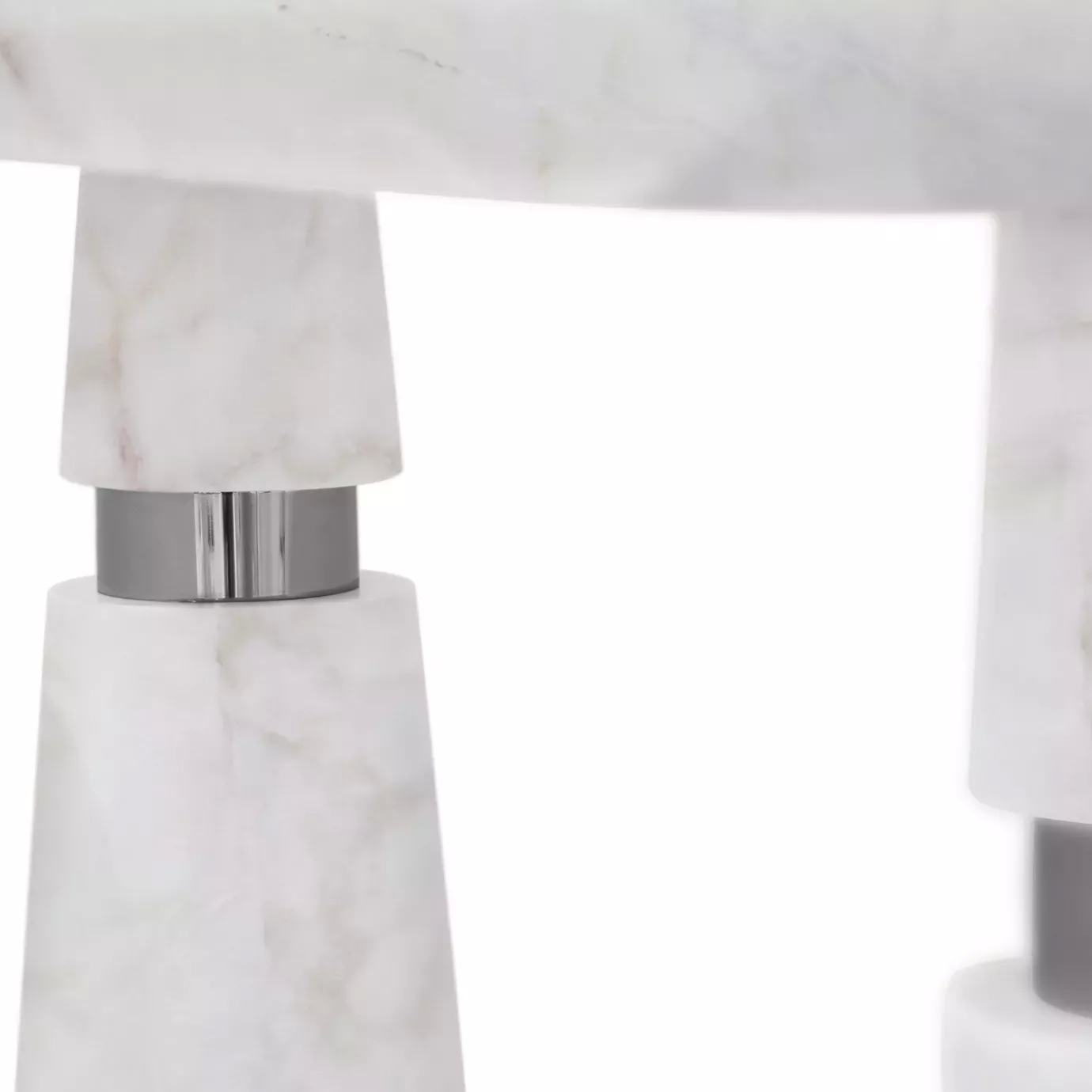 Close-up of the Avalanche Console: White Estremoz marble with conical legs and polished stainless steel rings.