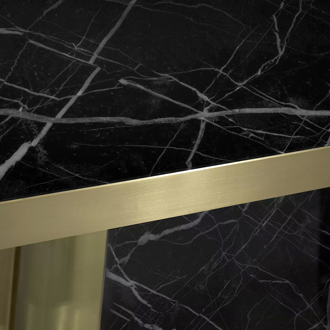 Close-up of the Decodiva Dining Table, highlighting the black Nero Marquina marble with white veins and a sleek gold trim.
