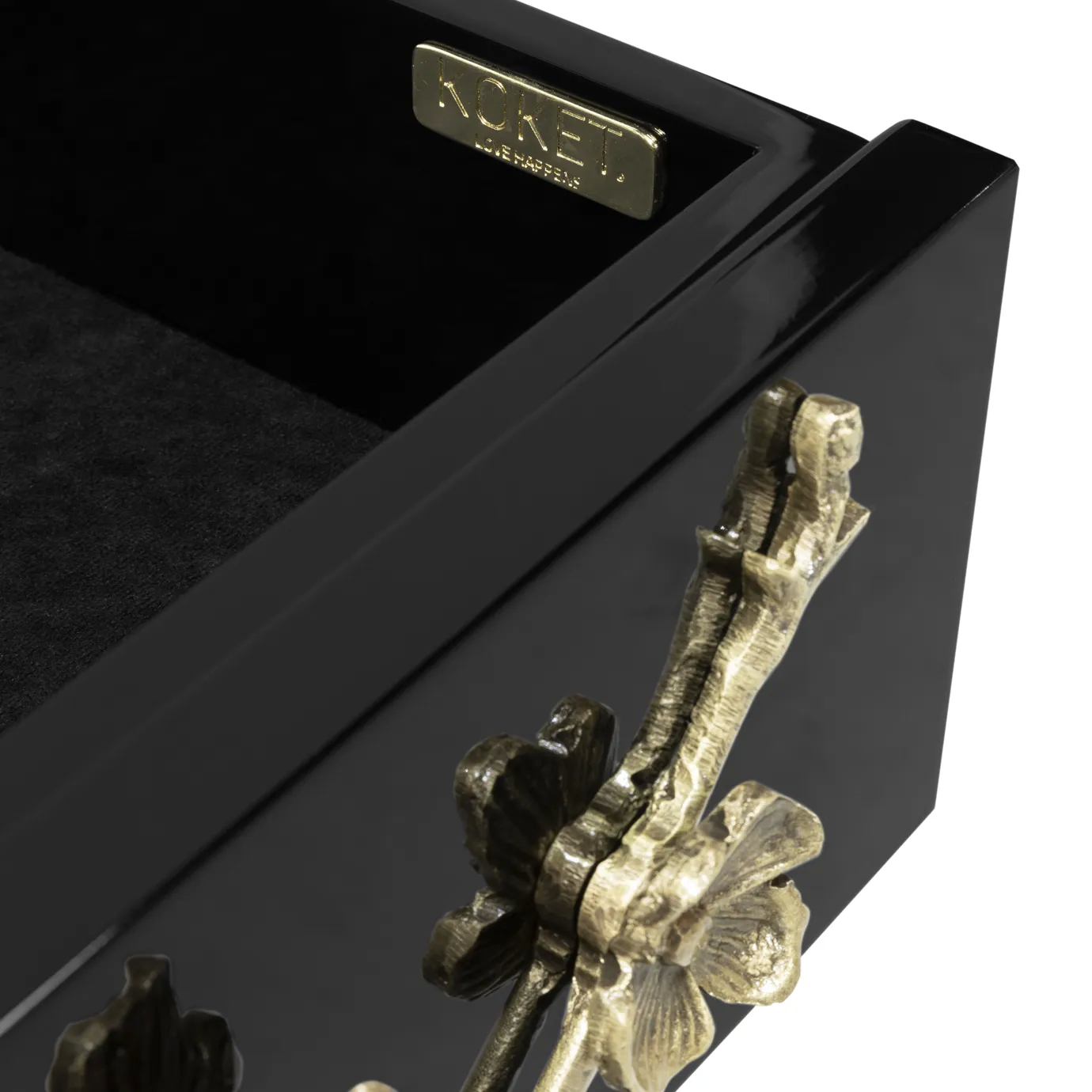 Close-up of the Spellbound Nightstand's open drawer, revealing a dark interior and a "KOKET Love Happens" plaque, with golden floral details.